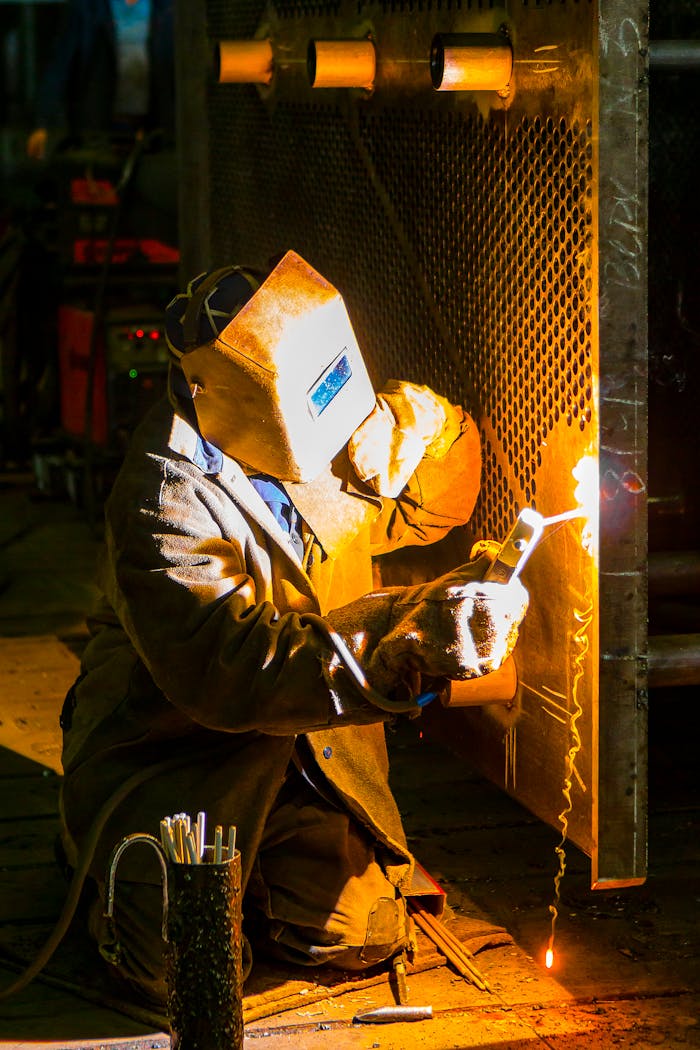 ours-journey A skilled welder works with a torch in an industrial environment, showcasing metalwork expertise.